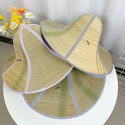 Stack of foldable woven straw sun hats
