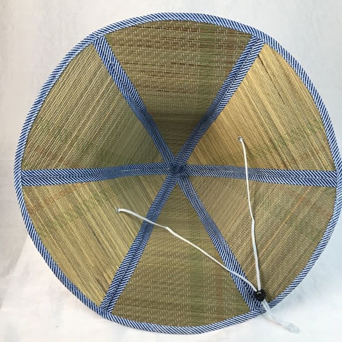 Interior underside of straw sun hat with adjustable chin strap cord